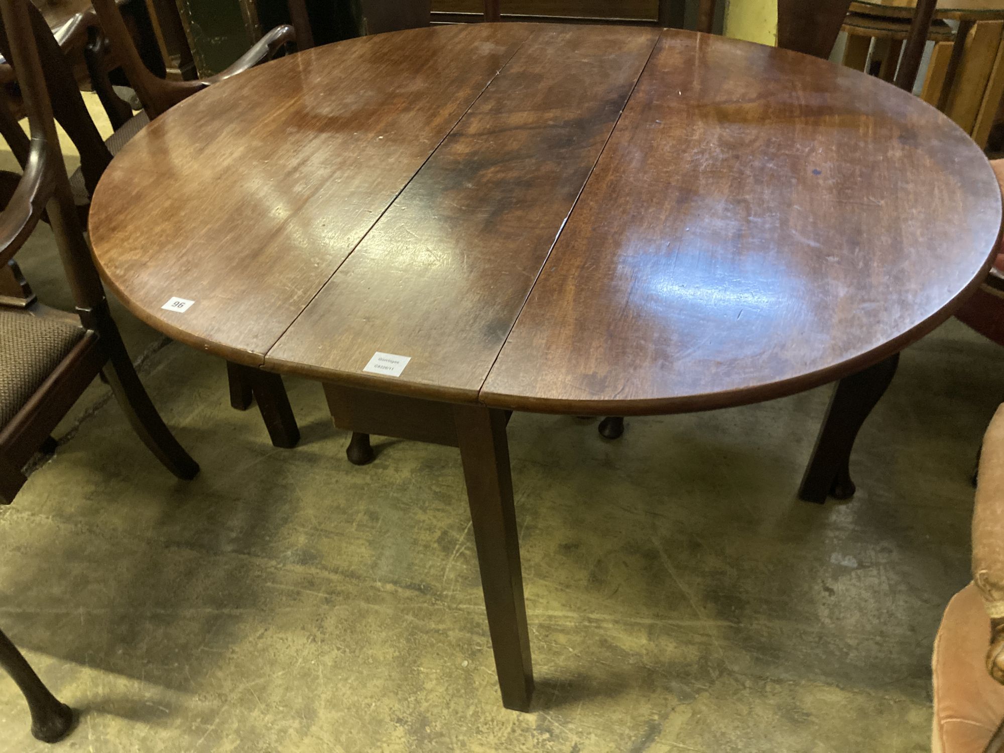 A George III mahogany cottage drop leaf dining table, width 106cm, length 128cm extended, height 70cm